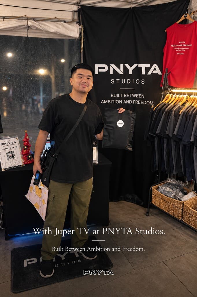 Juper TV holding a PNYTA bag in front of the Studios backdrop